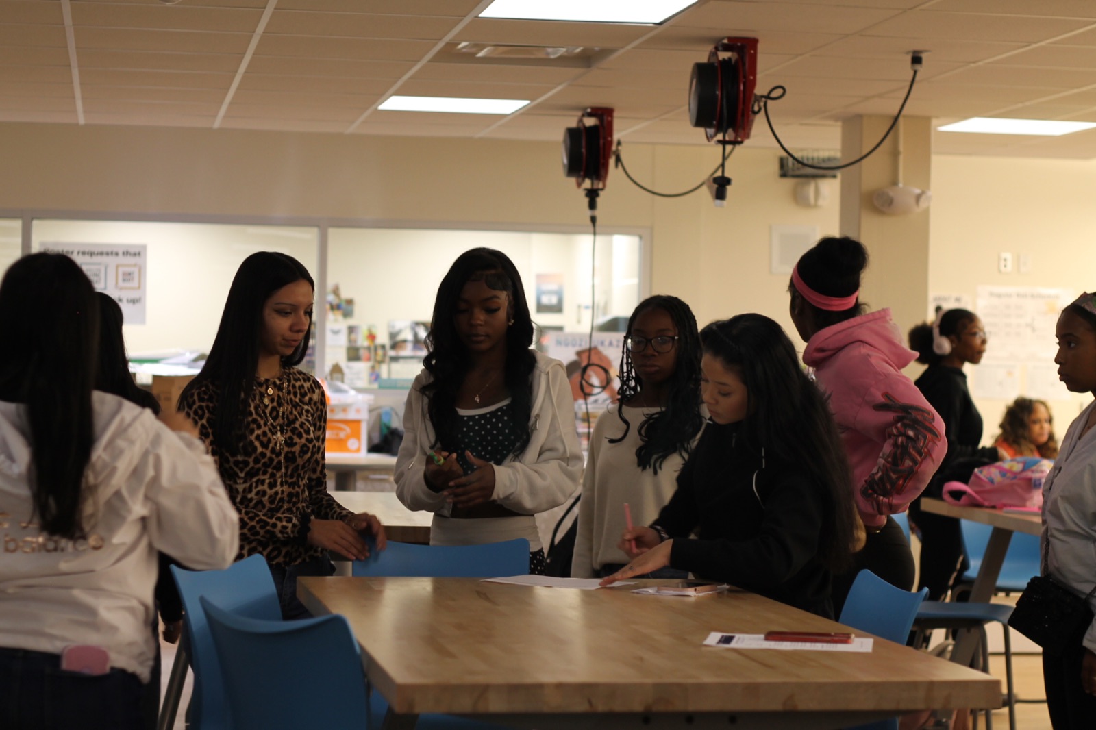 Students connect with professionals around a classroom activity table.